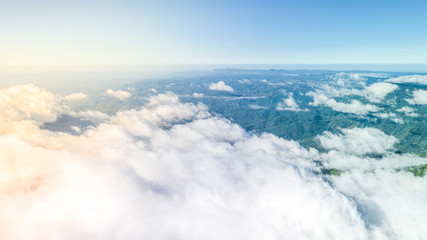 Fototapeta na wymiar Aerial view white clouds and green mountains cover by fog, Mountains view landscape.