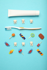 Teeth with sweet candies. Tooth caries in children's, dental healthcare, toothpaste and toothbrush.