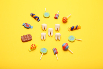 Teeth with sweet candies. Tooth caries in children's, dental healthcare.