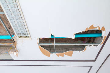 repair leak water pipe on gypsum ceiling interior office building