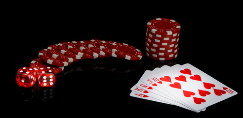 Obraz premium on a black background, red chips and dice, near the alignment in poker, street