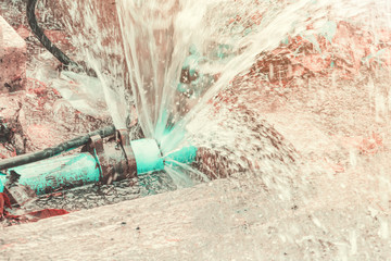 broken pipe in hole ditch at roadside and water Motion ( Teal and Orange Tone )