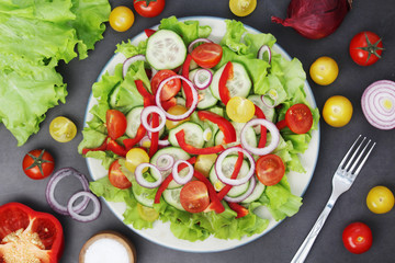 A plate full of bright fresh vegetable salad	