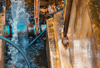 plumber working repair the broken pipe with Adjustable Wrenches or Locking Pliers in hole ditch at...