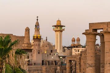 Fototapeta premium catholic Church and Muslim Mosque Tower religion Symbols together in Luxor temple at sunset