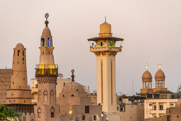 Fototapeta na wymiar catholic Church and Muslim Mosque Tower religion Symbols together in Luxor temple at sunset
