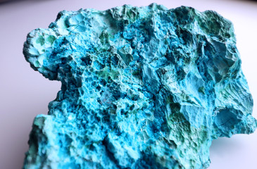 Closeup view of a Chrysocolla mineral, showing texture and vivid colors. 