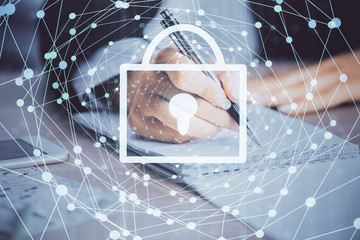 Double exposure of hands making notes with lock icons. Concept security and protection of data