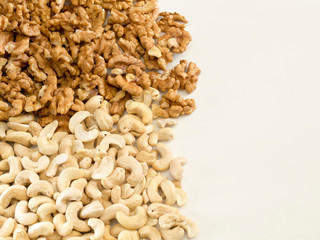 Walnuts and cashews on a completely white background.