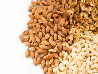 Walnuts, almonds and cashews on a completely white background.