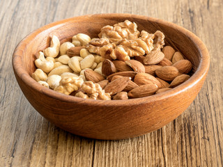 Nuts in a wooden bowl. Healthy nuts.