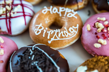 happy birthday multicoloured donuts inside white box