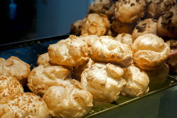 Closeup and crop giant puff cream on shelf in a bakery shop.
