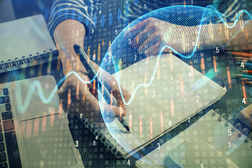 Financial chart drawn over hands taking notes background. Concept of research. Double exposure