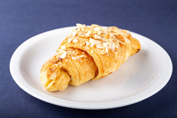 freshly baked croissants on a plate.