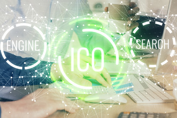 Crypto currency theme hologram with businessman working on computer on background. Concept of...