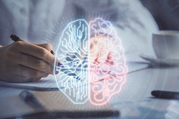 Multi exposure of woman's writing hand on background with brain hologram. Concept of brainstorming.