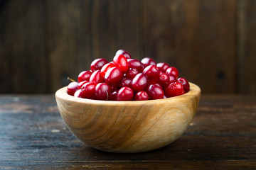 fresh cornel berries in brown bowl