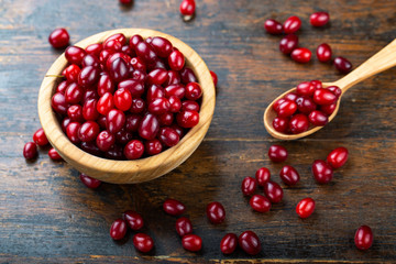 fresh cornel berries in brown bowl