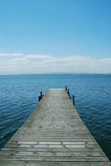 Fototapeta na wymiar Footbridge on the blue lake