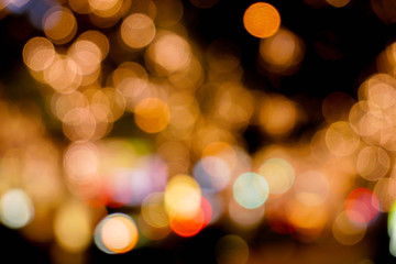 Abstract blurred and bokeh reflection lighting of decorate led light bubs on trees and city night life.