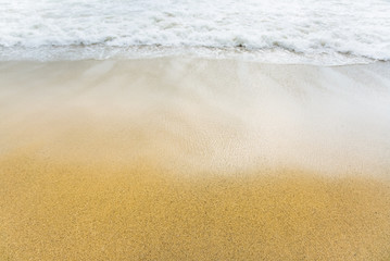 Beautiful sea coast. Waves with foam. Summer travel concept. Sand with buoy in water.