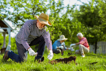 Man using gardening equipment while working in the garden