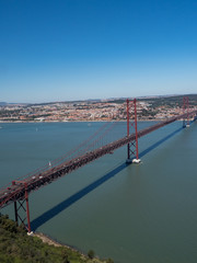 Fototapeta na wymiar Portugal, may 2019: The 25 April bridge (Ponte 25 de Abril) is a steel suspension bridge located in Lisbon, crossing the Targus river. It is one of the most famous landmarks of the region.