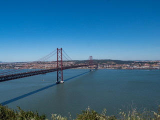 Portugal, may 2019: The 25 April bridge (Ponte 25 de Abril) is a steel suspension bridge located in Lisbon, crossing the Targus river. It is one of the most famous landmarks of the region.