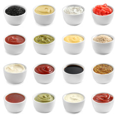Set of different delicious sauces on white background