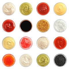 Set of different delicious sauces on white background, top view