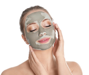 Beautiful woman with clay mask on her face against white background