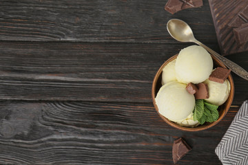 Fototapeta na wymiar Delicious vanilla ice cream with chocolate and mint served on wooden table, flat lay. Space for text