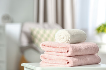 Clean soft terry towels on table indoors. Space for text