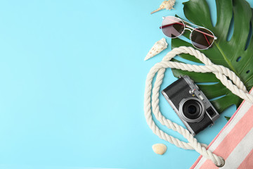 Flat lay composition with different beach objects on color background, space for text