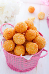 Deep fried cheese balls in a pink basket, selective focus