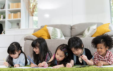 Group of little preschool kids drawing paper with color pencils . portrait of children friends education concept.