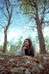 Young asian woman in an autumn park