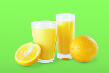 Two glasses with fresh orange juice with fruits on art green background.