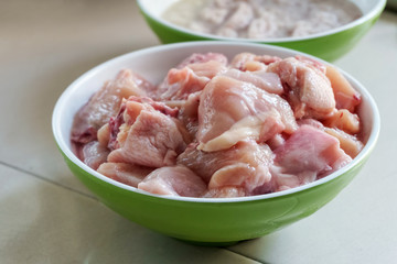 chopped and sliced raw chicken meat in a bowl