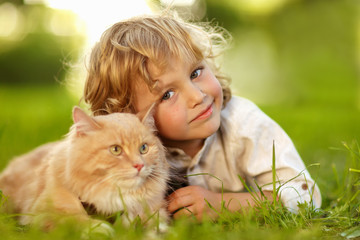 Little curly boy with a redhead cat