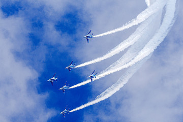 Blue Sky and aerobatics flying with White Smoke