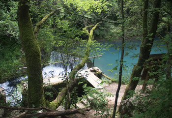 Amazingly beautiful mountain's spring with heavenly blue water color and small waterfall named Krupajsko Vrelo (spring of Krupaj), near Krupaja village, Eastern Serbia 