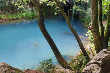 Amazingly beautiful mountain's spring with heavenly blue water color and small waterfall named Krupajsko Vrelo (spring of Krupaj), near Krupaja village, Eastern Serbia 
