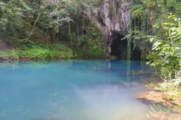 Amazingly beautiful mountain's spring with heavenly blue water color and small waterfall named Krupajsko Vrelo (spring of Krupaj), near Krupaja village, Eastern Serbia 