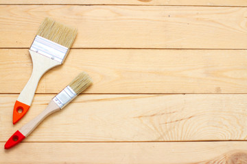 wooden background and paint brushes. free text space