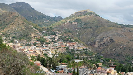 Taormina, Province of Messina, Sicily. View of part of the city, built on the hillside. Taormina was founded in the 4th century BC and is one of Sicily's most popular summer destinations.