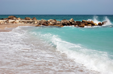 Landscape with waves and turquoise sea on the beach of the Romanian resort.