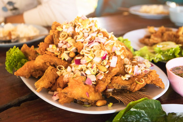 Deep fried fish and herb served with wild betel leafbush and delicious spicy sauce.