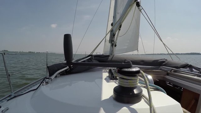 Onboard footage of small sailing boat a sloop is vessels with a headsail in front and a mainsail aft of the mast this configurations is called a fore-and-aft also known as bermuda rig 4k quality